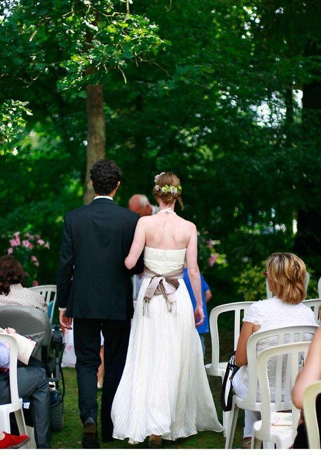 bride and groom walk down aisle together