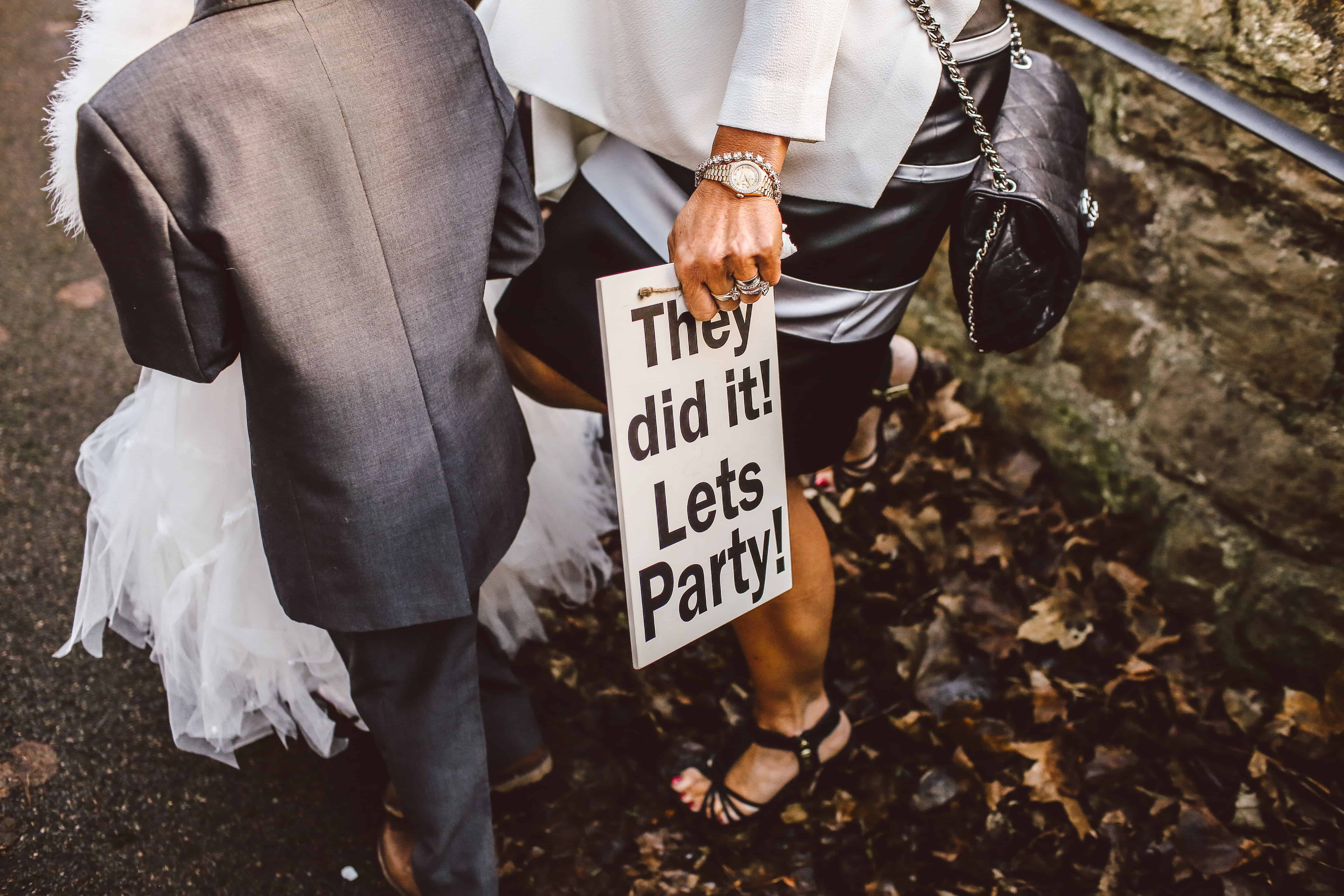 woman standing with boy while holding white signage