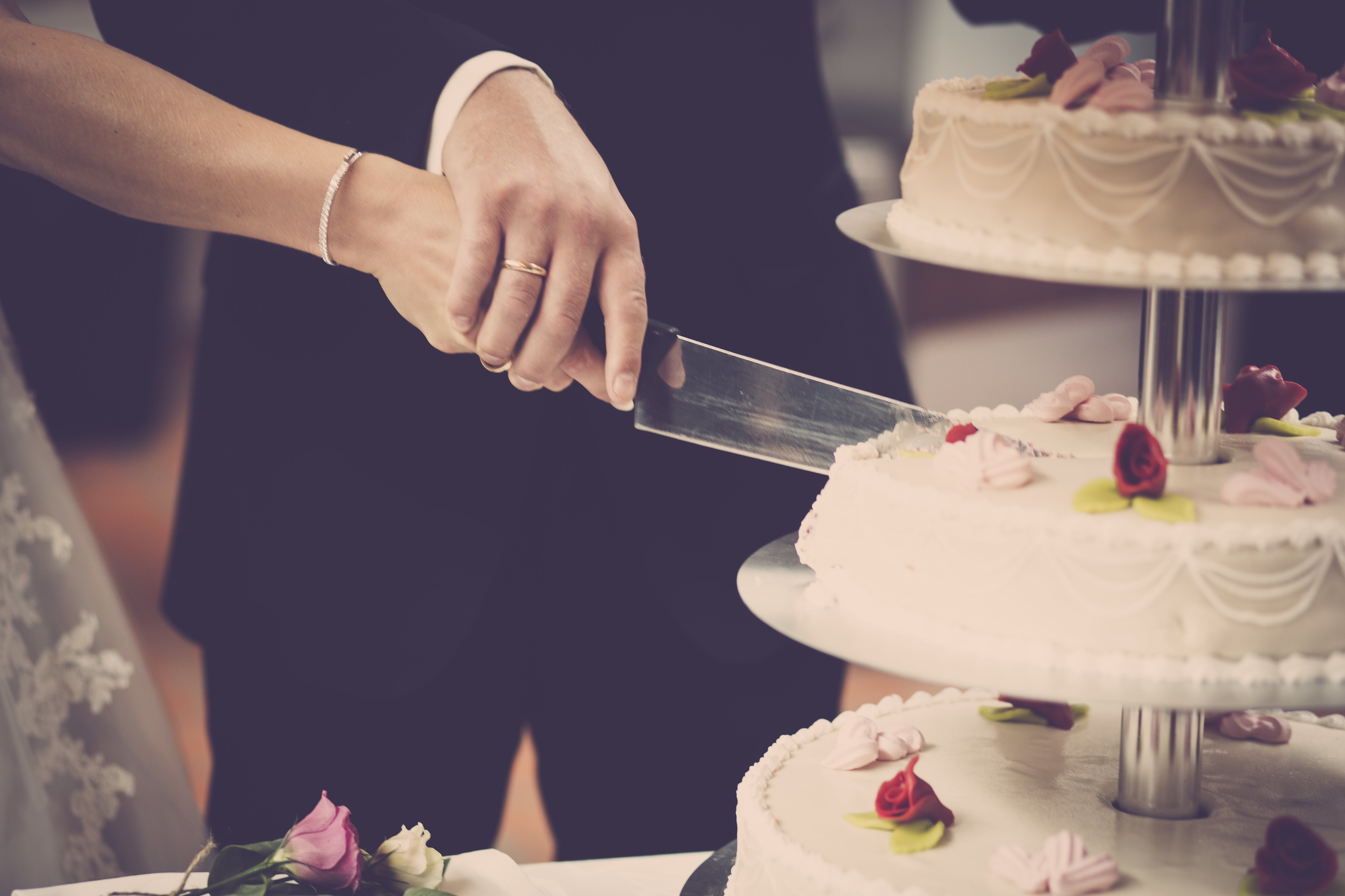 Free Person Holding Knife Slicing 3-layer Cake Stock Photo
