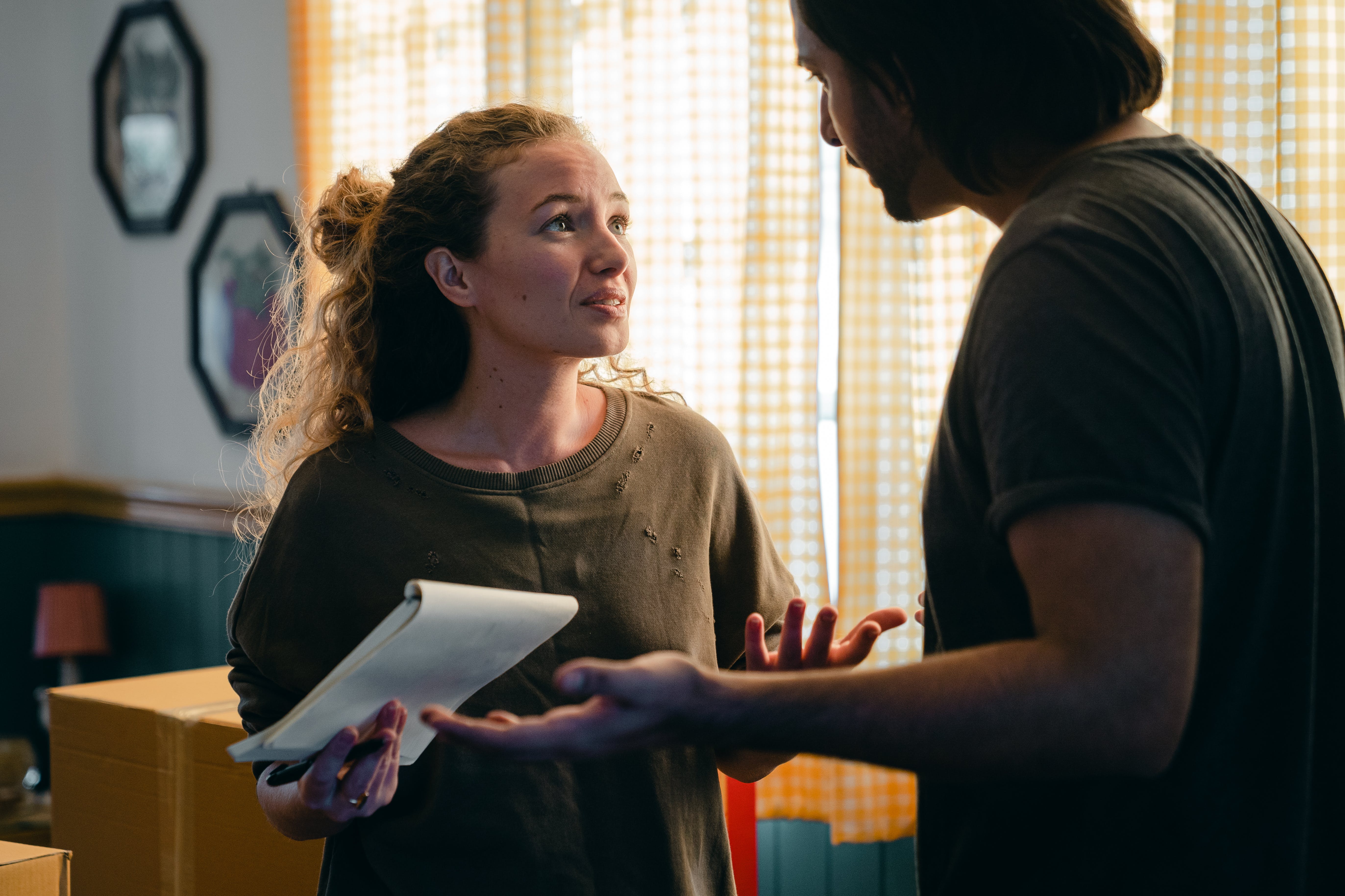 Free Worried couple with notebook looking at each other Stock Photo