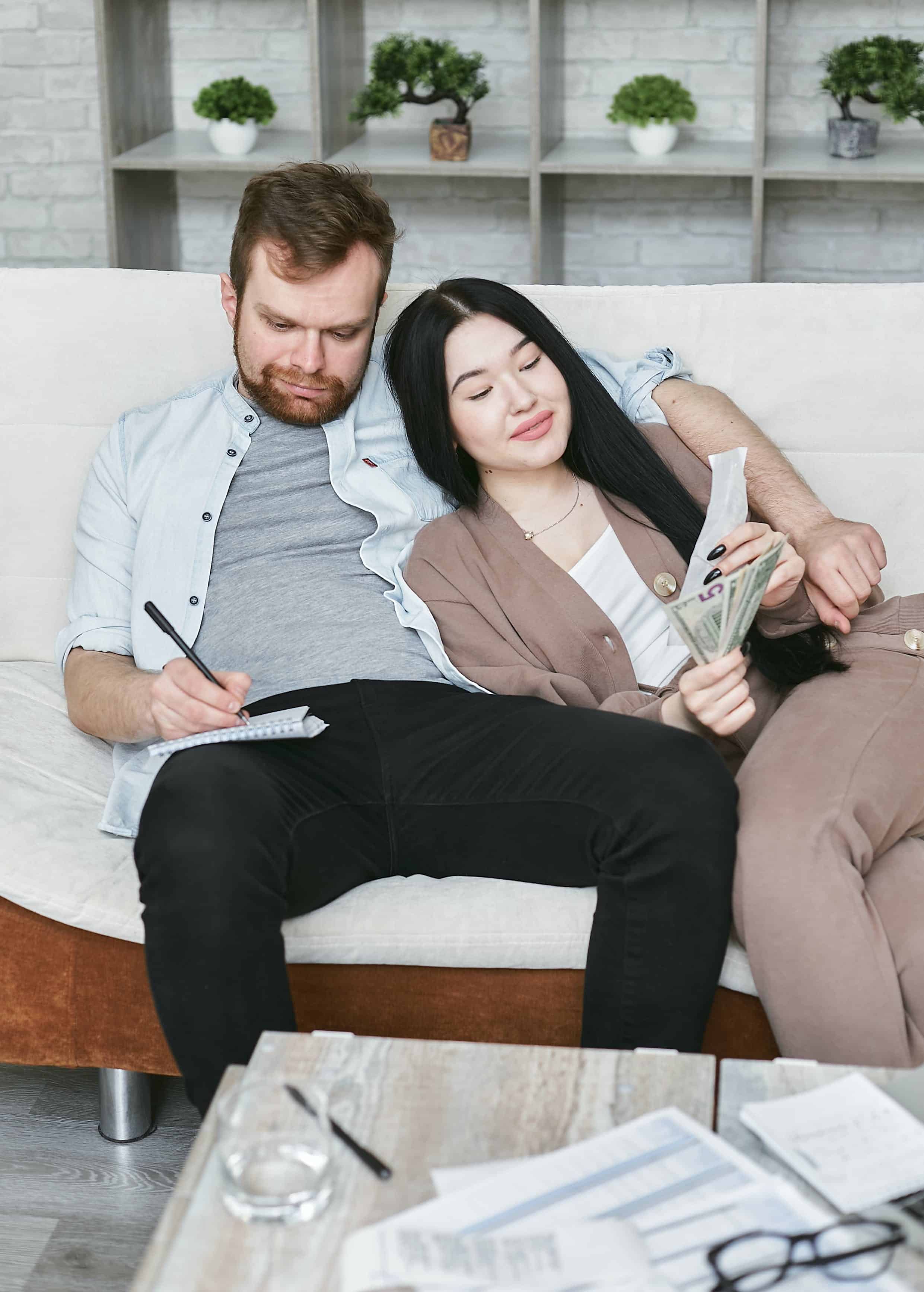 Free A Couple Sitting on a Couch Stock Photo