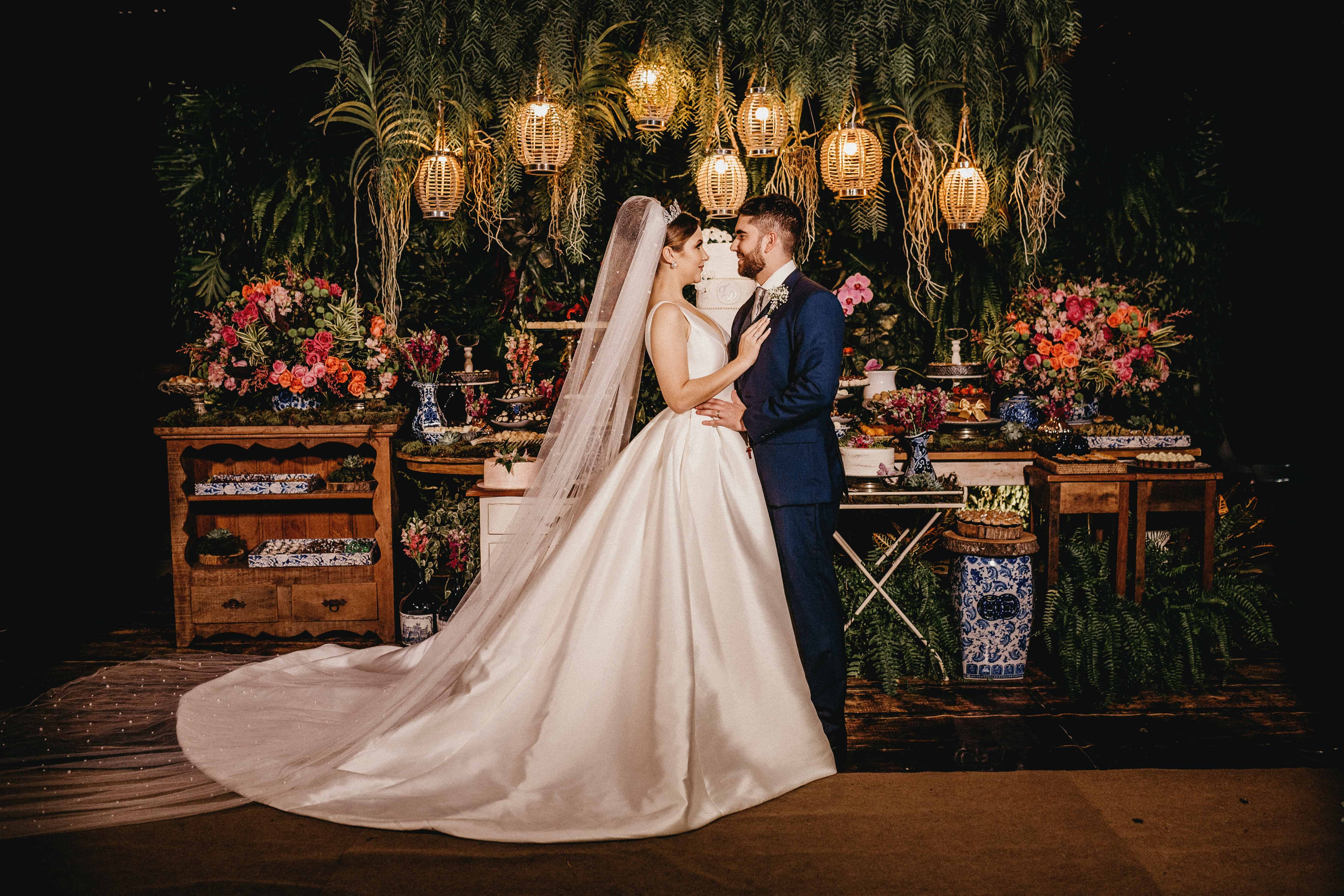 woman in white wedding gown standing beside brown wooden chair