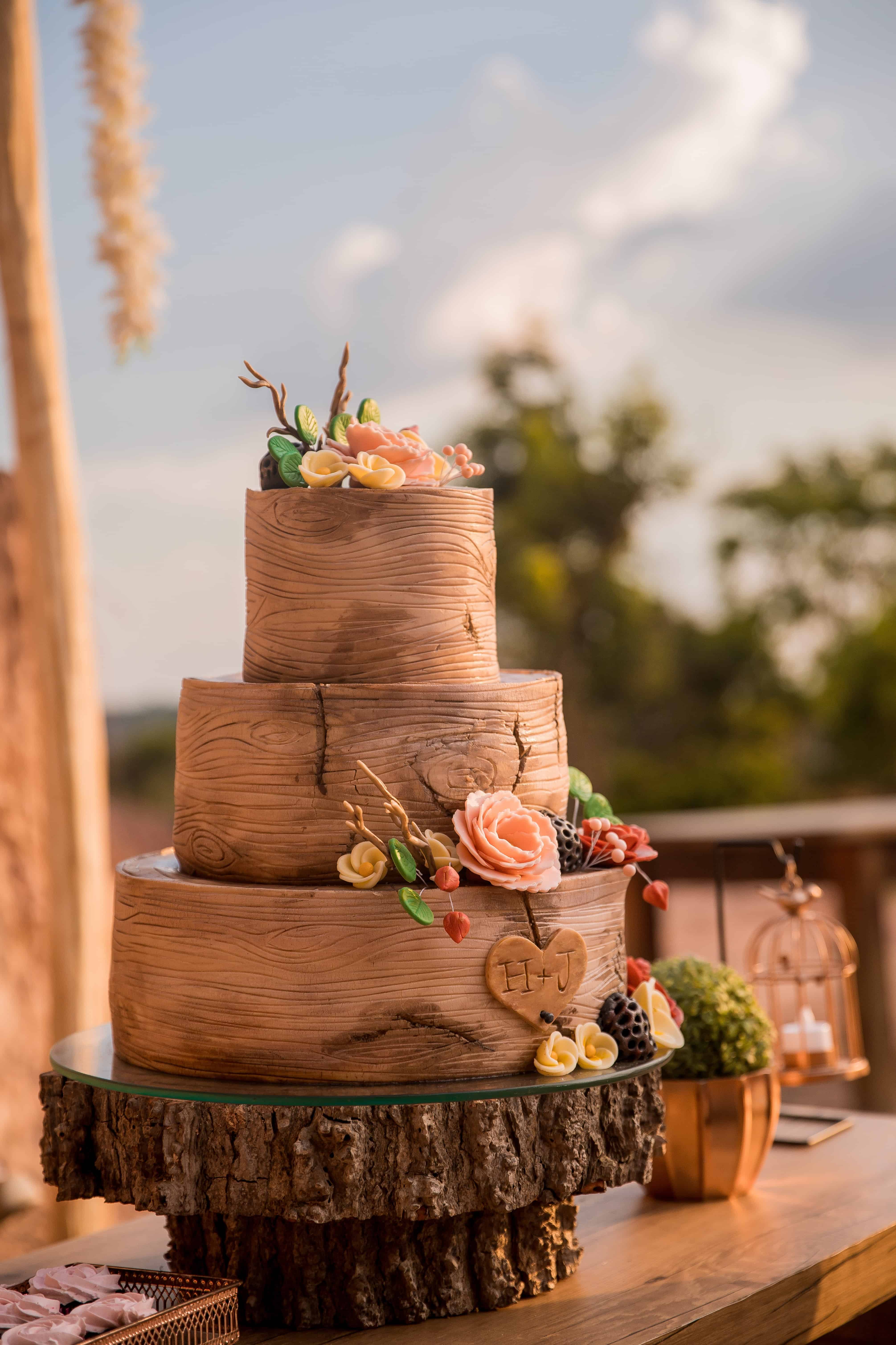brown and pink floral cake on brown wooden round table